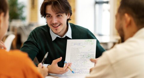 front-view-smiley-man-holding-paper-scaled-1